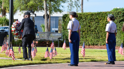JROTC students watching while a Veteran places a wreath