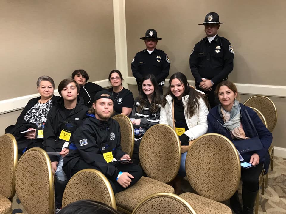Corporal Ray Weber (back left) and Sgt. Nick Dublino (back right) spend time with the family of late